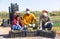 Group of farm workers in masks posing with crates at plantation