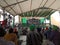 Group of farmers are gathering inside a large tent photograph