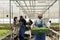 Group of farmers in modern greenhouse