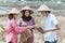 Group of farmers wearing a hat holding the crop and tablets