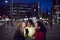 Group Of Female Friends On City Street At Night Ordering Taxi Using Mobile Phone App