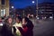 Group Of Female Friends On City Street At Night Ordering Taxi Using Mobile Phone App