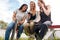 Group Of Female Friends With Skateboard Using Mobile Phones In Urban Skate Park