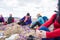 Group of female hikers in mountains during saffron blooming at spring