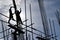 A group of Filipino Construction steel workers assembling steel bars on high-rise building with no proper protective suits and saf