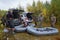 Group of fishermen prepares inflatable boats for fishing