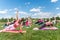 Group of fit girls going side plank exercise in nature on a sunny day.