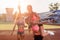 Group fit women giving piggyback ride Happy young friends enjoying a day at stadium.