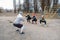 Group fitness workout classes outdoors. Socially Distant Outdoor Workout Classes in public parks. Three women and man