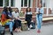 Group of five african college students spending time together on campus at university yard. Black afro friends studying at bench