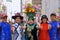 Group of five Asian people wearing colorful costumes at the Fifth Avenue Easter Parade.