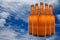 A group of five beer bottles in a diamond formation on sky background.