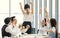 Group of five diverse businessmen, two men and three women at meeting desk. The woman feels excited and the team congrats. and