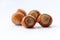 Group of five filbert hazelnuts on white background,