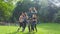 Group of five fit happy women giving high five in park after workout,celebrating success.Setting goals, achieving team