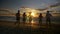 Group of five friends running together towards the sea on a beach at sunset - slow motion