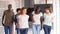 Group of five multi ethnic teenagers happy back to school smiling in the hallway