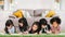 Group of five multi-ethnic young cute preschool kids, boy and girls happy studying or drawing together at home or school