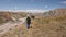 A group of five people are walking in the Pamir mountains. Trekking near the base camp under Lenin Peak, Kyrgyzstan.