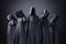 Group of five scary figures in hooded cloaks