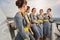 Group of five stewardesses having a conversation outside