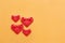 group of folding red paper hearts on yellow concrete wall for pa