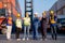 Group of foreman and cargo container workers or technician stand in row and show thumbs up to camera for symbol of successful in