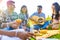 group of four best friends in the park having picnic on a sunny evening