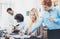 Group of four coworkers discussing business plans in an office. Young people making great ideas. Horizontal, blurred background.