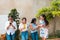 Group of four friends standing with their cell phones