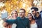 Group of four funny friends taking selfie