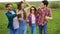 Group of four happy smiling friends walks with sparklers at slow motion.