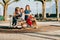 Group of four kids having fun on playground