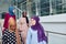 Group of four muslim girls walking at stairs of shopping mall