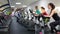 Group of four people in the gym, exercising their legs doing cardio training. Positive females of different age training