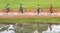 Group of four people riding bike or cycling and the reflection o