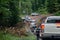 A Group of four wheeler cars passing through the unpaved road.