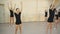 Group of four young ballerinas standing in row and practicing ballet