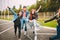 Group of four young diverse friends in jeanse outfit look carefree, young and happy on city`s streets