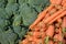 Group of fresh carrots and broccoli on a fruit market