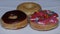 A group of fresh decorated donuts on a white background