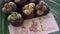 Group of fresh exotic tropical thai fruit mangosteens garcinia mangostana with national currency baht rotating on