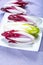 Group of fresh green Belgian endive or chicory and red Radicchio vegetables, also known as witlof salade