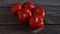 A group of Fresh and Healthy Ripe Red Tomatoes on wooden Table.