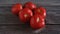 A group of Fresh and Healthy Ripe Red Tomatoes on wooden Table.