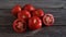 A group of Fresh and Healthy Ripe Red Tomatoes on wooden Table.