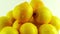 A Group of Fresh Lemons Rotating Against a White Background