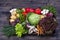 Group of fresh, raw vegetables on rustic wooden table tray. Selection includes carrot, potato, cucumber, tomato, cabbage, lettuce,