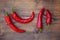 Group of fresh red hot chilli peppers on an old vintage wooden table