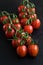 Group of fresh tomatoes on black background